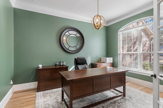 home office featuring baseboards, light wood-type flooring, a notable chandelier, and crown molding