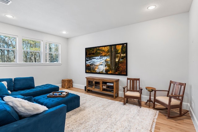 living area featuring recessed lighting, visible vents, baseboards, and wood finished floors