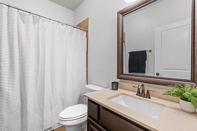 bathroom featuring toilet and vanity