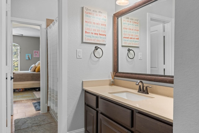 ensuite bathroom with a textured wall, ensuite bath, vanity, and shower / bathtub combination with curtain