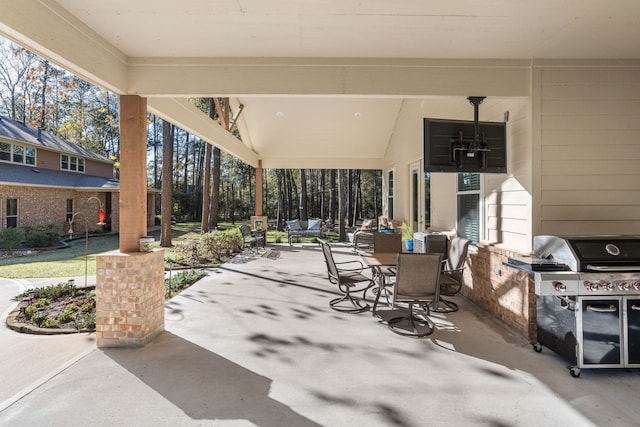 view of patio featuring outdoor dining space, area for grilling, and exterior kitchen