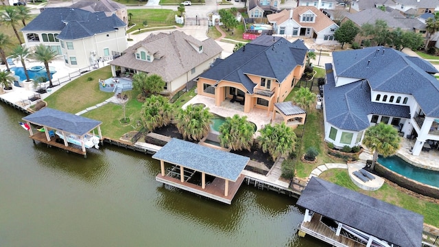 birds eye view of property featuring a water view and a residential view