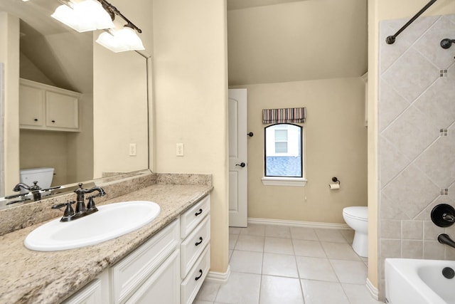 bathroom featuring baseboards, toilet, tile patterned floors, vaulted ceiling, and vanity