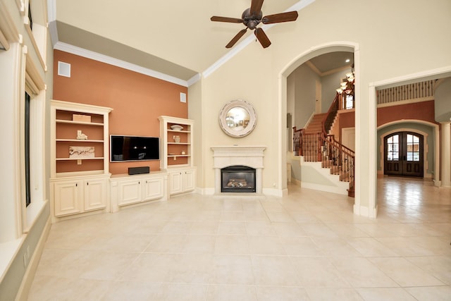 2256 Lake Cove Way, Seabrook, TX 77586 - unfurnished living room featuring high vaulted ceiling, a glass covered fireplace, light tile patterned flooring, ceiling fan, and stairs