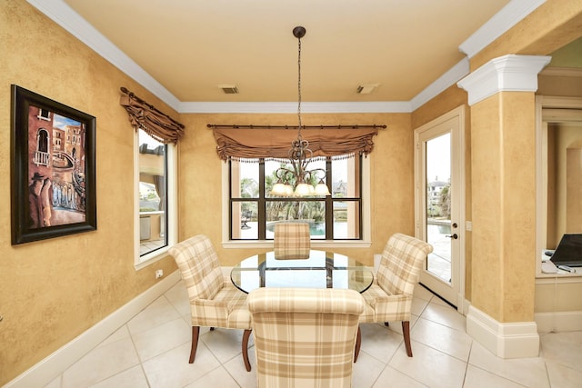 sitting room featuring a healthy amount of sunlight, ornate columns, crown molding, and an inviting chandelier