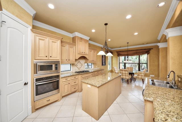 kitchen with appliances with stainless steel finishes, light stone counters, decorative light fixtures, light brown cabinets, and a sink