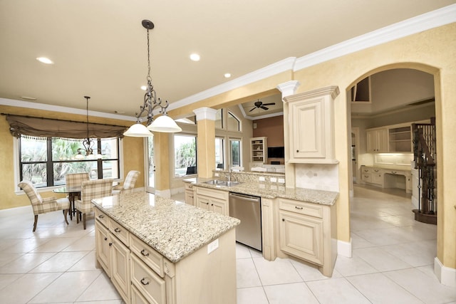 kitchen featuring light stone counters, cream cabinets, hanging light fixtures, ornamental molding, and stainless steel dishwasher