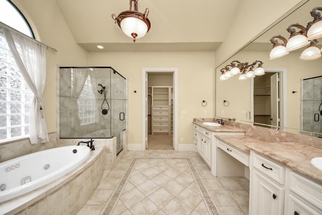 bathroom with a shower stall, a spacious closet, baseboards, and vanity