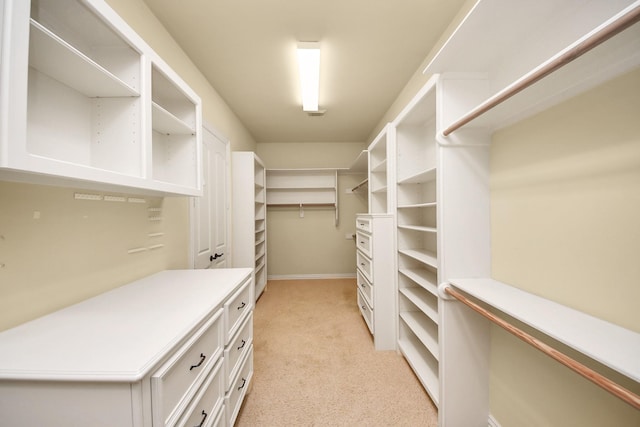 walk in closet featuring light colored carpet