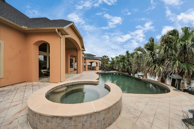 view of swimming pool featuring a patio area and a pool with connected hot tub