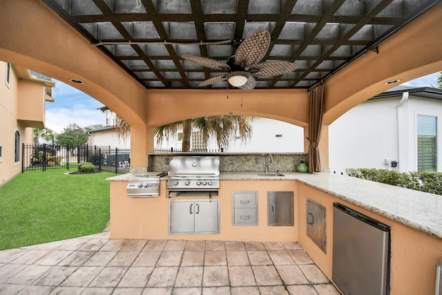 view of patio featuring area for grilling, a sink, a grill, a ceiling fan, and fence