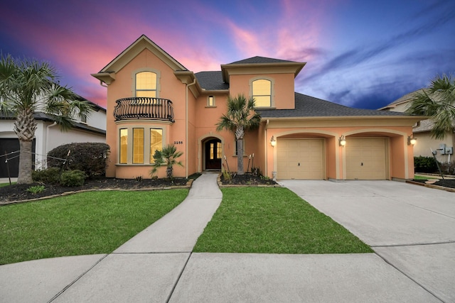 2256 Lake Cove Way, Seabrook, TX 77586 - mediterranean / spanish house featuring stucco siding, concrete driveway, a lawn, and an attached garage