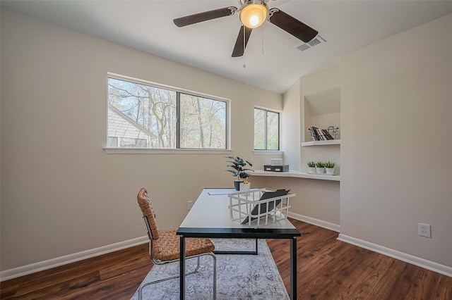 office area featuring a ceiling fan, visible vents, wood finished floors, and baseboards