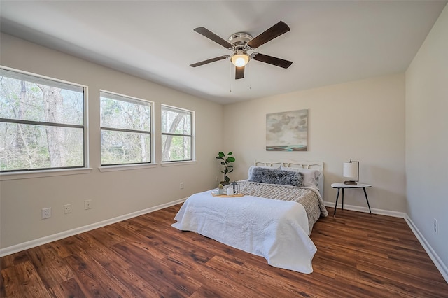 bedroom with ceiling fan, baseboards, and wood finished floors