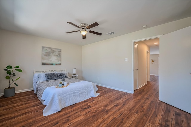 bedroom with a ceiling fan, baseboards, and wood finished floors