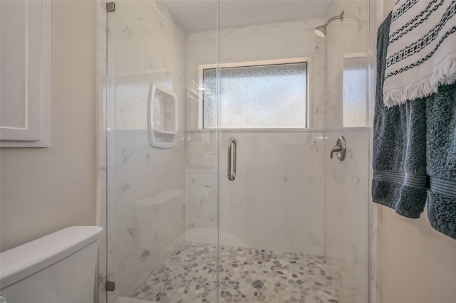 full bathroom featuring a marble finish shower and toilet