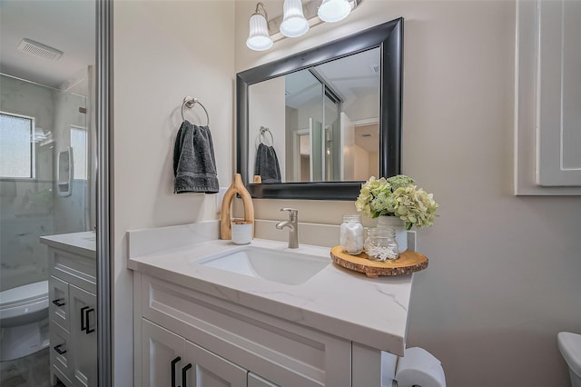 full bathroom with visible vents, toilet, a stall shower, and vanity