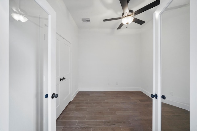 spare room featuring baseboards, visible vents, a ceiling fan, french doors, and wood finish floors