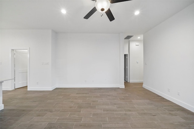 empty room with light wood-type flooring, visible vents, baseboards, and recessed lighting