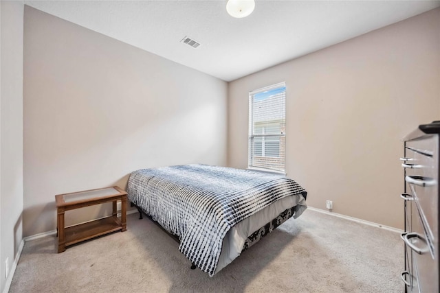 bedroom with light colored carpet, visible vents, and baseboards