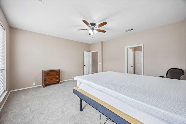 bedroom with baseboards, ceiling fan, visible vents, and light colored carpet