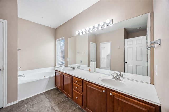 bathroom with double vanity, tile patterned floors, a sink, and a bath