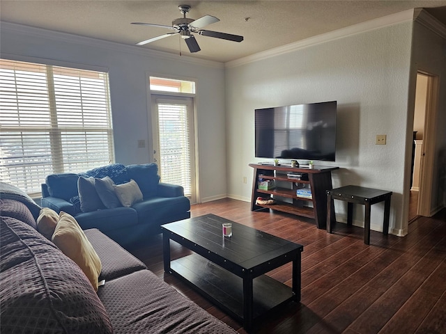 living room featuring baseboards, a textured wall, hardwood / wood-style flooring, ceiling fan, and ornamental molding