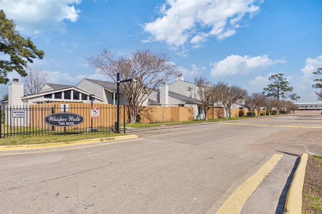 view of street featuring street lighting, a residential view, and curbs