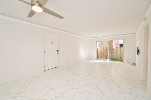 spare room with baseboards, marble finish floor, ceiling fan, and crown molding