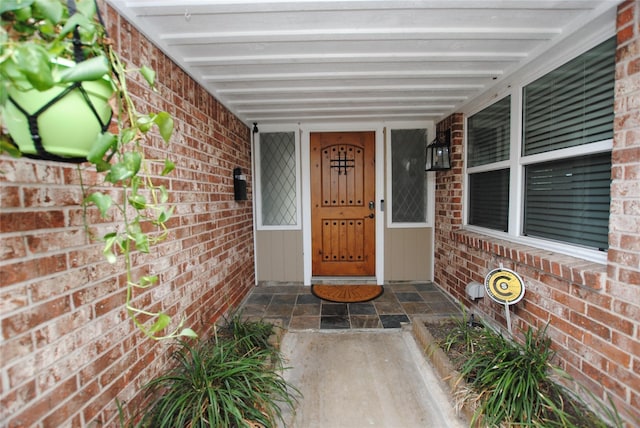 property entrance with brick siding