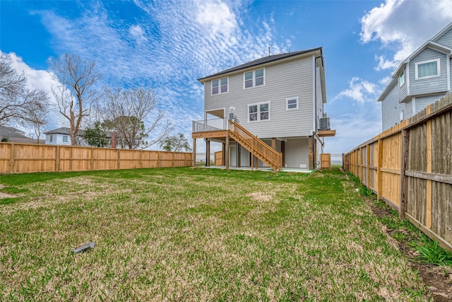 back of property featuring a fenced backyard, stairs, a wooden deck, and a yard