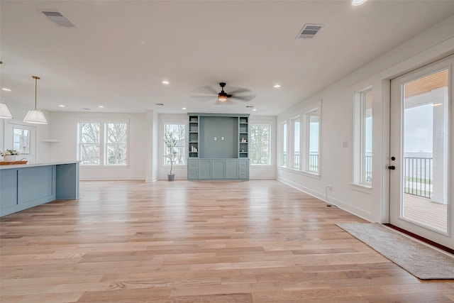 unfurnished living room with baseboards, light wood-style flooring, visible vents, and recessed lighting