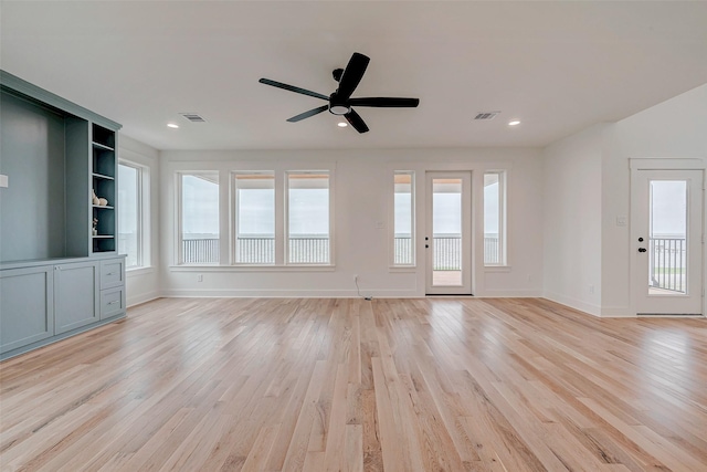 unfurnished living room featuring light wood-type flooring, baseboards, and visible vents