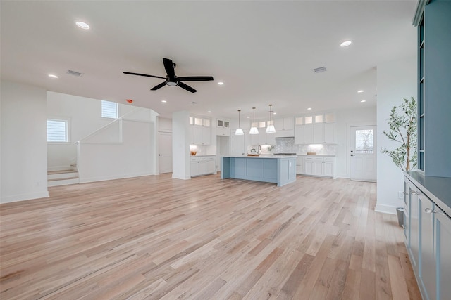 unfurnished living room featuring a ceiling fan, recessed lighting, visible vents, and light wood finished floors