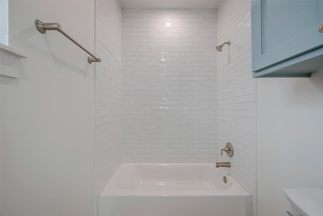 bathroom featuring toilet and tub / shower combination