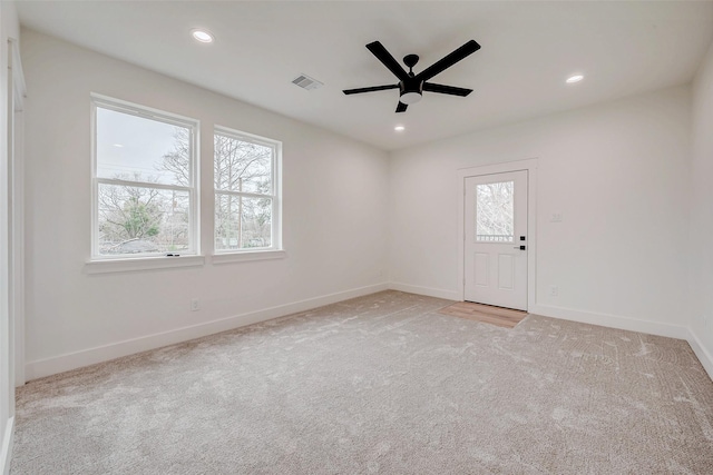 unfurnished room featuring recessed lighting, plenty of natural light, visible vents, and light colored carpet