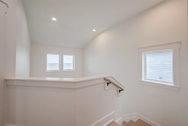 stairway with lofted ceiling, baseboards, and recessed lighting