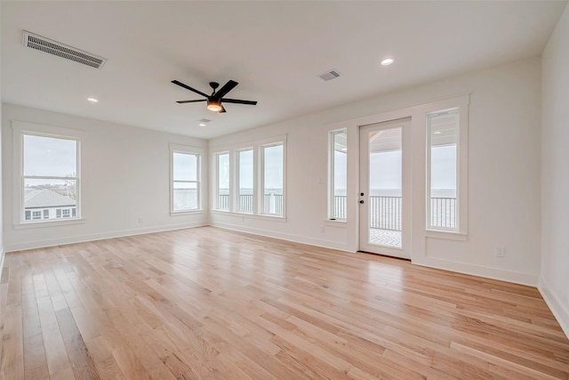 unfurnished living room featuring light wood-style floors, baseboards, visible vents, and a ceiling fan