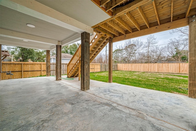 view of patio featuring a fenced backyard and stairway