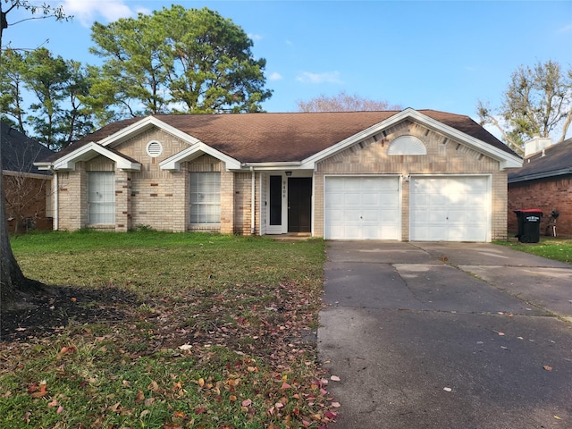 ranch-style house with brick siding, a shingled roof, an attached garage, driveway, and a front lawn