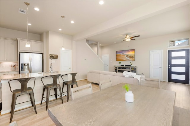 dining room with a ceiling fan, light wood-type flooring, visible vents, and recessed lighting