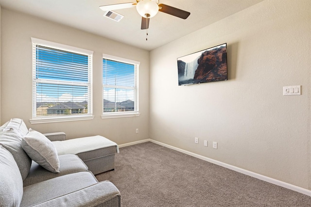 living area featuring visible vents, carpet, a ceiling fan, and baseboards