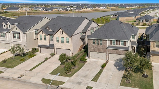 aerial view with a water view and a residential view