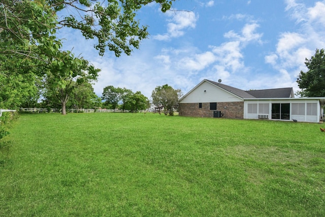 view of yard featuring cooling unit and fence