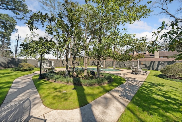 surrounding community featuring a swimming pool, fence, and a lawn