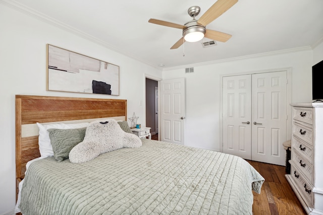 bedroom featuring dark wood-style floors, visible vents, and crown molding