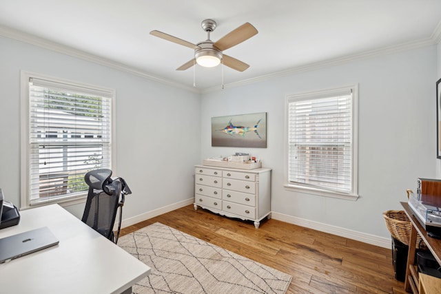 office area with baseboards, crown molding, and wood finished floors