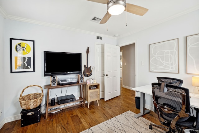 office area featuring ornamental molding, a ceiling fan, visible vents, and wood finished floors