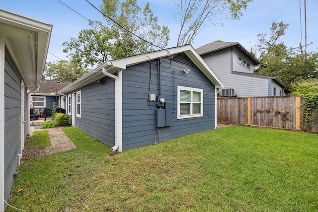 back of house with fence, cooling unit, and a yard