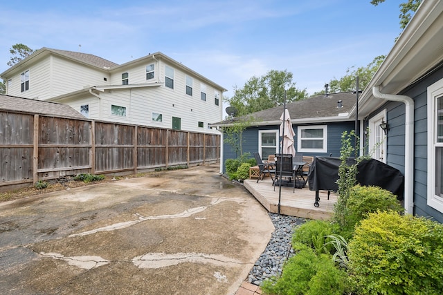 view of patio featuring a deck, outdoor dining space, fence, and grilling area